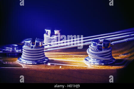 Closeup view on bass guitar tuning machines. Stock Photo