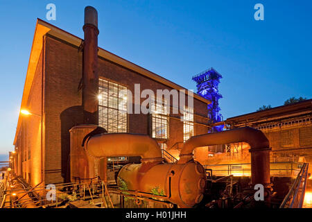 illuminated former compressor hall and cooling tower of coking plant Hansa in the evening, Germany, North Rhine-Westphalia, Ruhr Area, Dortmund Stock Photo