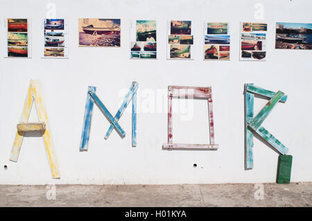 Fuerteventura, Canary Islands, North Africa: the word Love, Amor in Spanish, composed by wooden pieces of old boats on a white wall in El Cotillo Stock Photo
