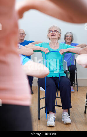 Group Of Seniors Using Resistance Bands In Fitness Class Stock Photo