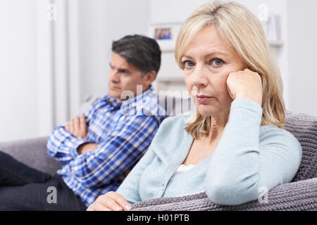 Mature Couple With Relationship Difficulties Sitting On Sofa Stock Photo