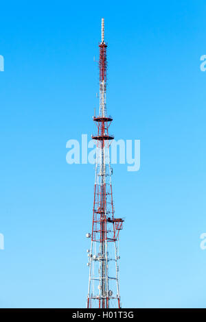 Telecommunication tower with radio devices over blue sky background Stock Photo