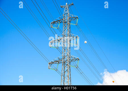 Lattice-type steel tower as a part of high-voltage line. Overhead power line details. Stock Photo