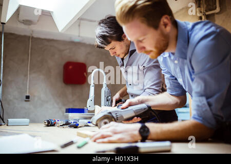 Two designers working on a project in workshop with joint effort Stock Photo