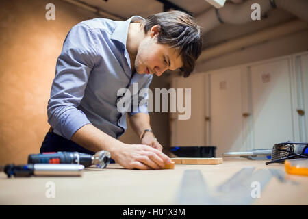 Joiner working and designing on workbench in workshop Stock Photo