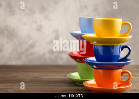 Two stacks multicolored cups on table from right side Stock Photo