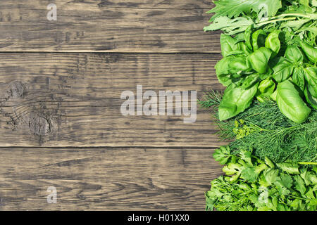Various herbs from right side of wooden background Stock Photo