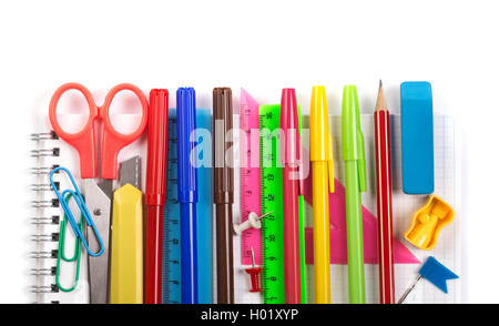 Various stationery items on notebook on white Stock Photo