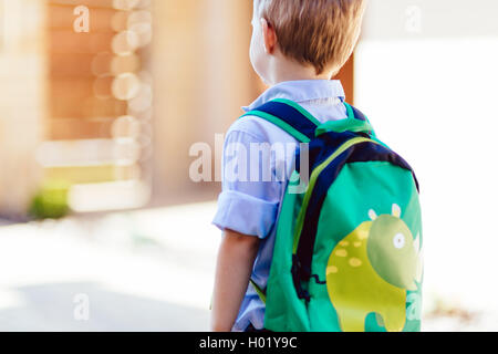 Child leaving home to his first day of kindergarten Stock Photo