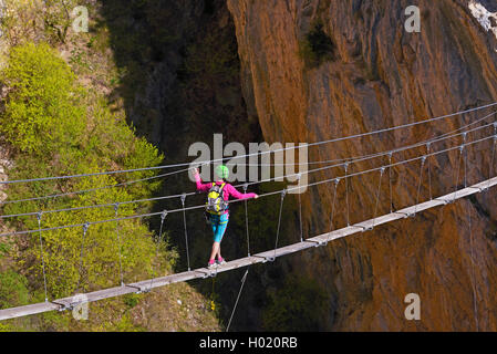 female climber on hanging bridge, via ferrata de la Grande Fistoire, France, Caire, Sisteron Stock Photo