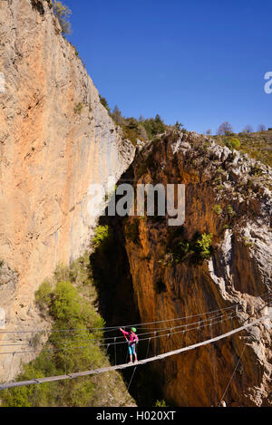 female climber on hanging bridge, via ferrata de la Grande Fistoire, France, Caire, Sisteron Stock Photo