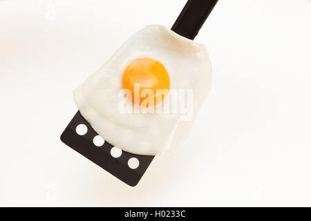 Appetizing and Perfectly Fried Egg on a Spatula, isolated on white background Stock Photo