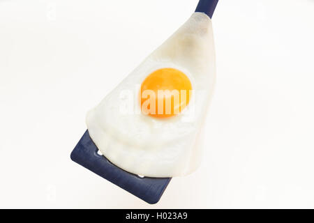 Appetizing and Perfectly Fried Egg on a Spatula, isolated on white background Stock Photo