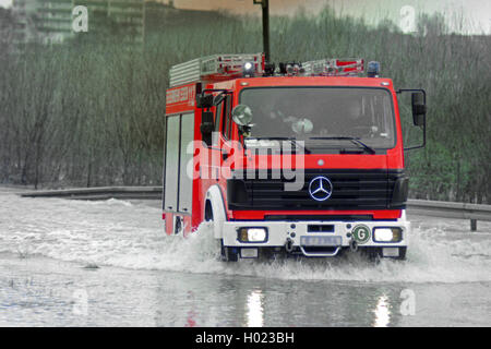 fire brigade car passing through high water, Germany, North Rhine-Westphalia