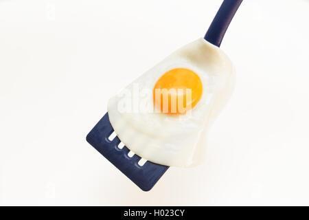 Appetizing and Perfectly Fried Egg on a Spatula, isolated on white background Stock Photo