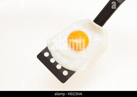 Appetizing and Perfectly Fried Egg on a Spatula, isolated on white background Stock Photo