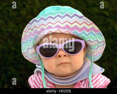 baby with sun hat and sun glasses in the summer heat, Austria Stock Photo