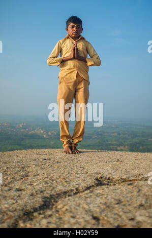 KAMALAPURAM, INDIA - 03 FEBRUARY: Indian pilgrim with hands in praying position on hilltop Stock Photo