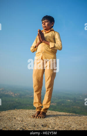 KAMALAPURAM, INDIA - 03 FEBRUARY: Indian pilgrim with hands in praying position on hilltop Stock Photo