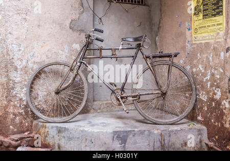 VARANASI, INDIA - 25 FEBRUARY 2015: Traditional Indian bicycle parked in corner of street. Bicycles are very common means of tra Stock Photo