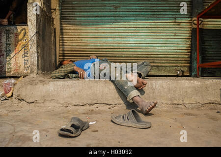 JODHPUR, INDIA - 10 FEBRUARY 2015: Drunk Indian man passed out on street. Stock Photo