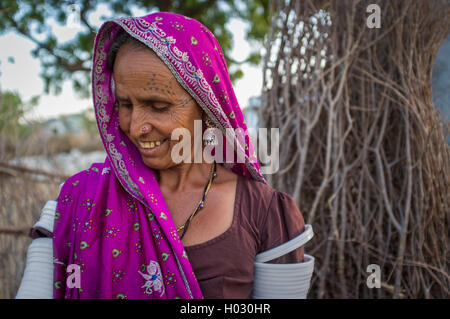 GODWAR REGION, INDIA - 12 FEBRUARY 2015: Tribeswoman decorated with traditional tattoos on face, jewelry and upper arm bracelets Stock Photo