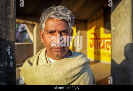 GODWAR REGION, INDIA - 14 FEBRUARY 2015: Adult Indian man with grey hair stands in street. Stock Photo