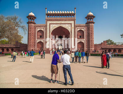 AGRA, INDIA - 28 FEBRUARY 2015: South side of Great Gate in Taj Mahal area with tourist and guide preparing to take a photo. Stock Photo