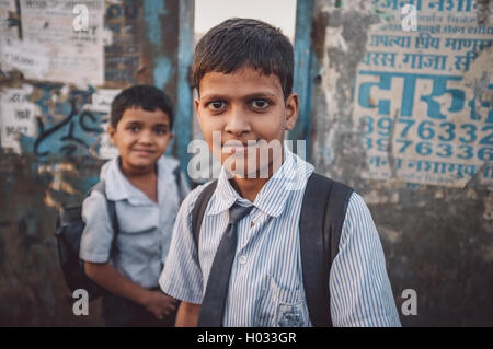 MUMBAI, INDIA - 12 JANUARY 2015: Indian school boys on bridge in Dharavi slum. Post-processed with grain, texture and colour eff Stock Photo