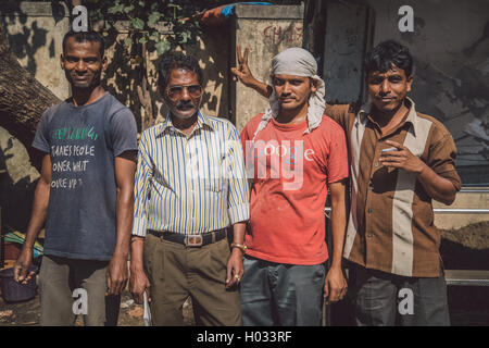MUMBAI, INDIA - 09 JANUARY 2015: Three Indian men stand with construction manager. One man teases manager. Post-processed with g Stock Photo