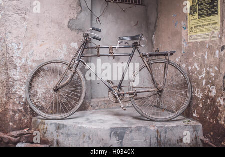 VARANASI, INDIA - 25 FEBRUARY 2015: Traditional Indian bicycle parked in corner of street. Post-processed with grain, texture an Stock Photo