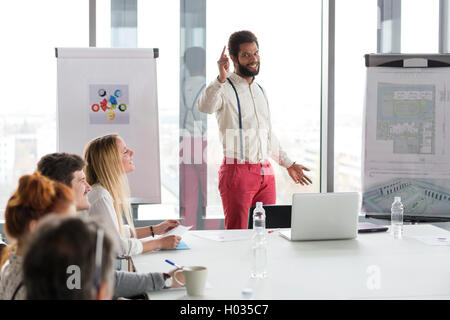 Hipster business man presenting the project in modern office. Stock Photo