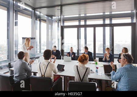 Business people clapping hands after successful meeting  in modern office. Stock Photo