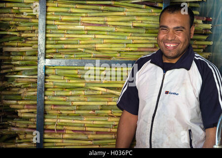 ASWAN, EGYPT - FEBRUARY 5, 2016: Local vendor smiling in front of the sugar cane juice shop. Stock Photo