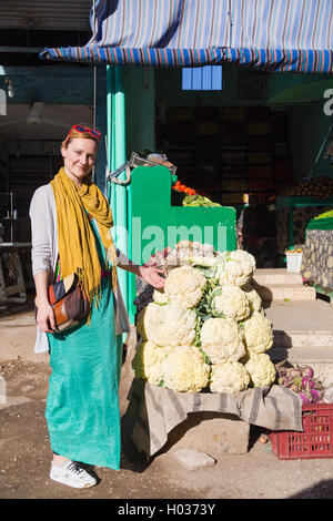 DARAW, EGYPT - FEBRUARY 6, 2016: Tourist standing by the vegetable stand at Daraw market. Stock Photo