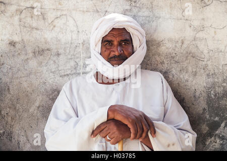 DARAW, EGYPT - FEBRUARY 6, 2016: Portrait of local camel salesman in white clothes and turban. Stock Photo