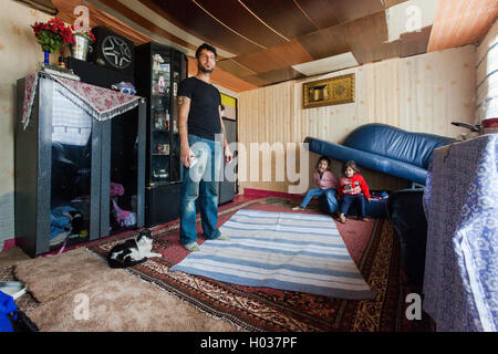 ZAGREB, CROATIA - OCTOBER 21, 2013: Roma man and his family at their home. Stock Photo