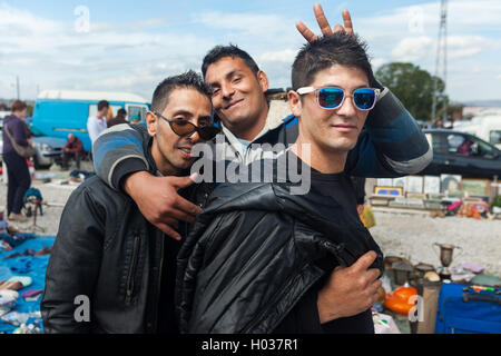 ZAGREB, CROATIA - OCTOBER 20, 2013: Roma salesmen posing for camera at Zagreb's flea market Hrelic. Stock Photo