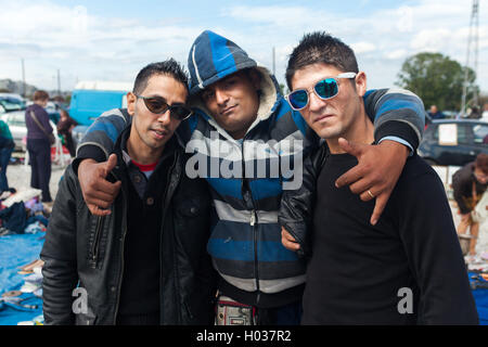 ZAGREB, CROATIA - OCTOBER 20, 2013: Roma salesmen posing for camera at Zagreb's flea market Hrelic. Stock Photo