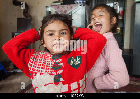 ZAGREB, CROATIA - OCTOBER 21, 2013: Portrait of little Roma girls at their home. Stock Photo