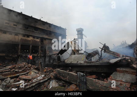 Firefighters are working to put out a fire at a Tampaco packaging factory in Tongi industrial area outside Dhaka, Bangladesh. Stock Photo