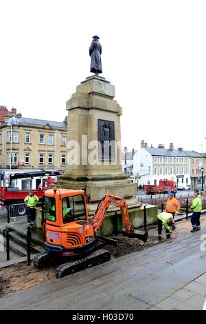 Workmen improving the area around the Cenotaph at Barnsley Town Hall, South Yorkshire, UK. Stock Photo