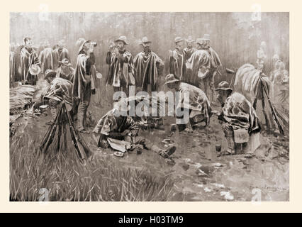 The rainy season in the Philippines.  American soldiers stop for a rest and food during the Philippine-American War, 1899. After the drawing by Frederic Remington. Stock Photo