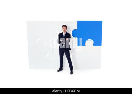 Portrait of business man and puzzle isolated on white background Stock Photo