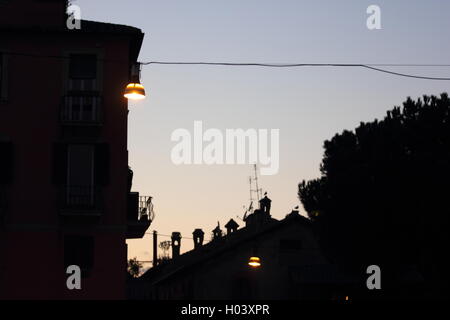 beautiful street lamps and silhouetted buildings at dusk , Rome, Italy, travel Stock Photo