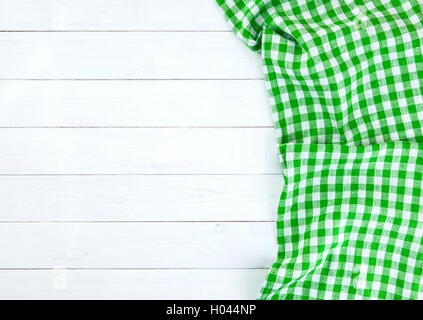 Green tablecloth on white wood table Stock Photo