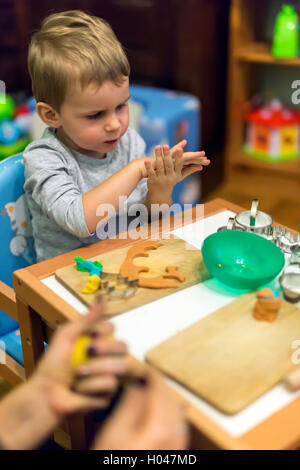Little boy being creative with playdough Stock Photo