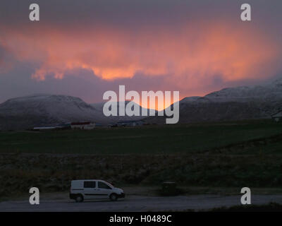 A White Van on a Mountain Road under the Beautiful Evening Sky of Iceland Stock Photo