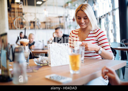Beautiful woman enjoying beverages in nice cafe Stock Photo
