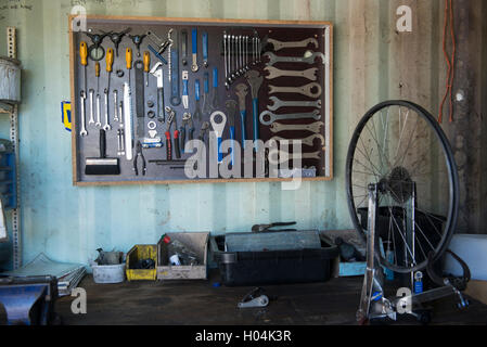 Workbench of a bicycle mechanic with tools arranged on a wall, Cape Town, South Africa Stock Photo